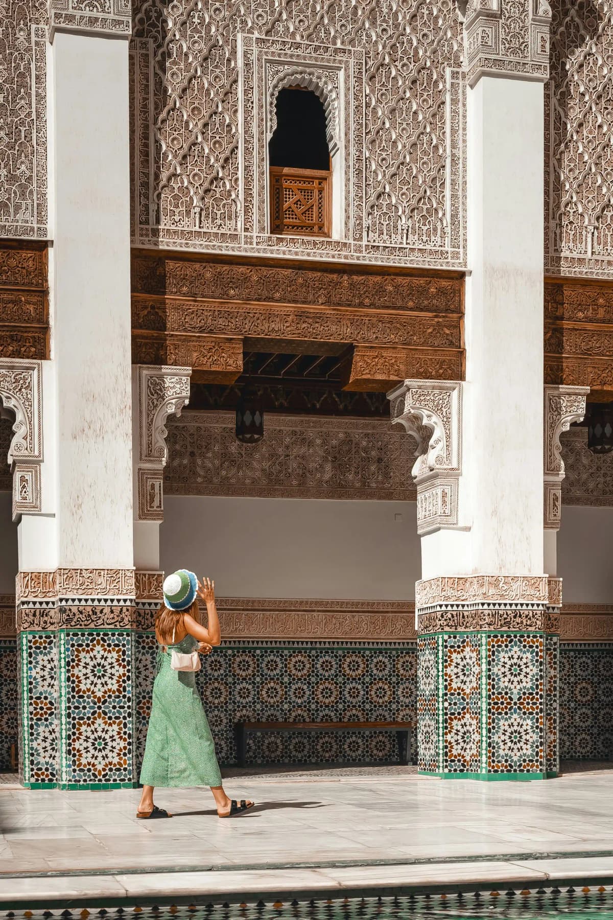 woman sitting in a peaceful traditional riad courtyard in marrakech