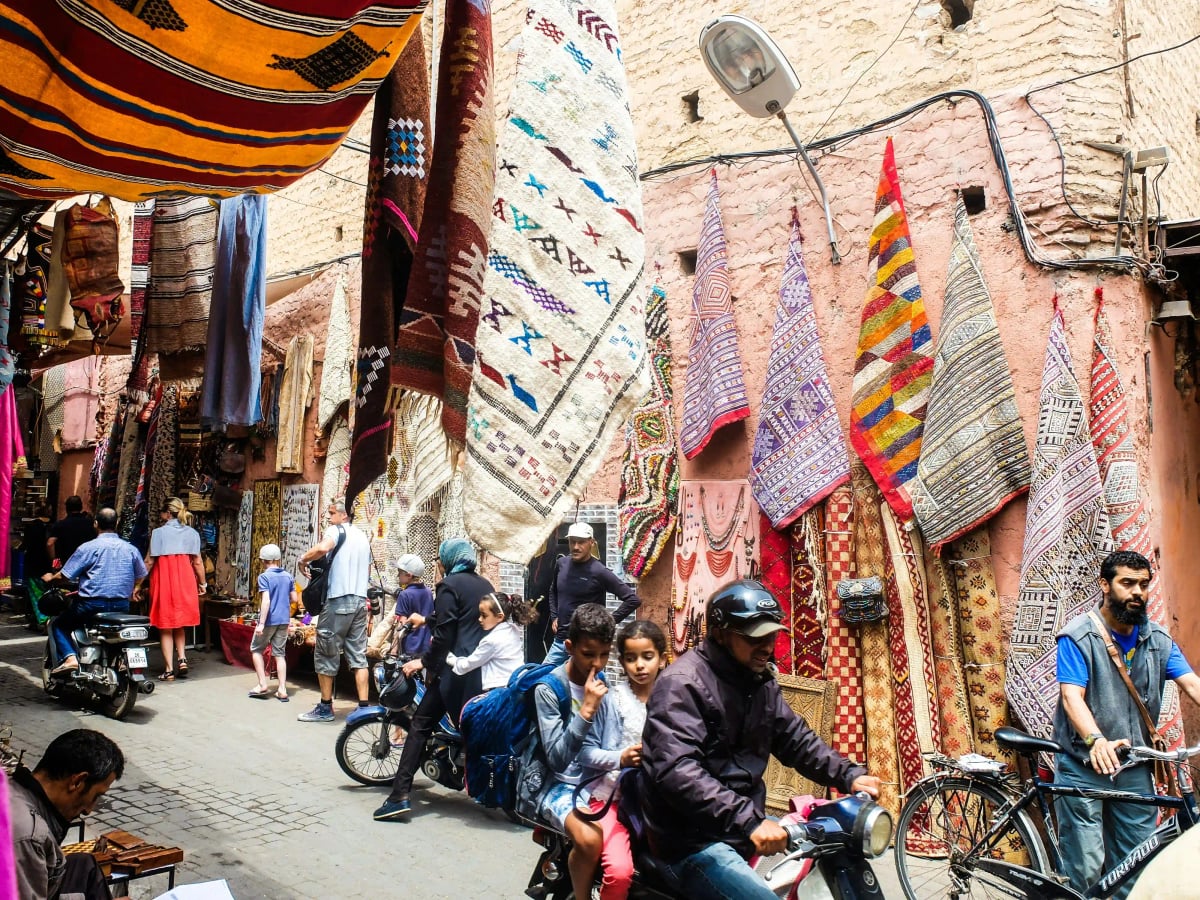 Moroccan people in traditional dress at a local souk in Marrakech
